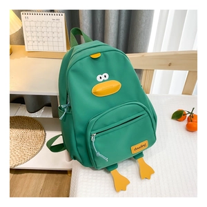 Close-up of green cartoon duck backpack with signature yellow beak and 3D feet detail
