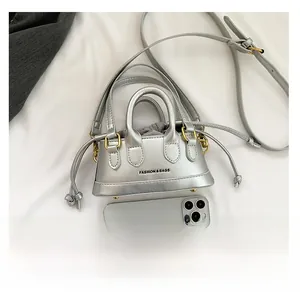 Mini silver metallic handbag with drawstring liner and phone for size comparison
