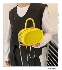 Mini yellow crossbody bag with pearl chain detail and textured finish