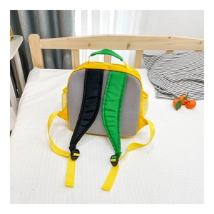 Detail view of the breathable mesh back and padded shoulder straps on the yellow kids backpack