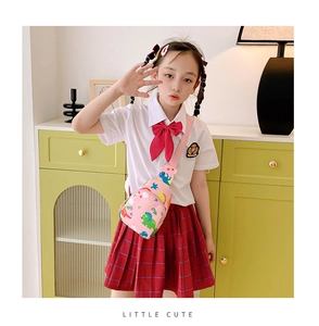 Close-up of pink girls' dinosaur crossbody bag with adjustable strap and cute patterns