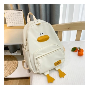 Detail of cute 3D duck face design and feet on cream canvas backpack for kids