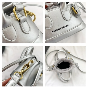Detail of silver metallic mini bag showing drawstring closure and gold hardware hooks
