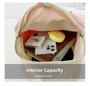 Internal capacity of contrast color canvas backpack showing phone and stationery