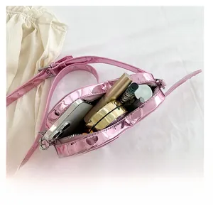 Pink metallic crossbody bag interior view showing capacity for phone and cosmetics