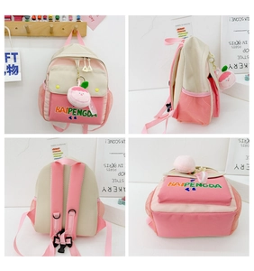 Detail view of pink canvas toddler backpack with mesh back and peach plush keychain