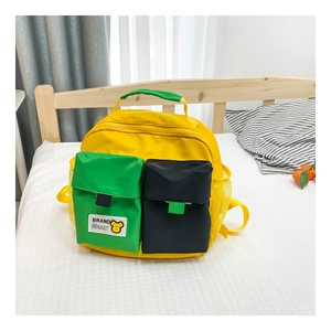 Close-up of lightweight kids canvas backpack with yellow, green and blue contrast pockets