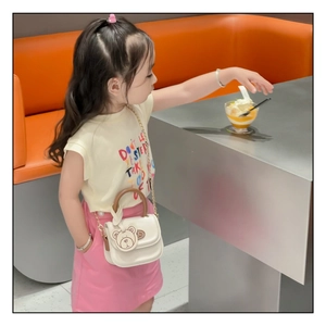 Mini white PU crossbody bag for kids featuring a cute 3D bear charm and wooden handle