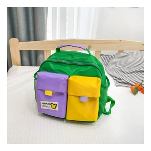 Detail view of colorful kids canvas backpack with green, purple and yellow contrast pockets