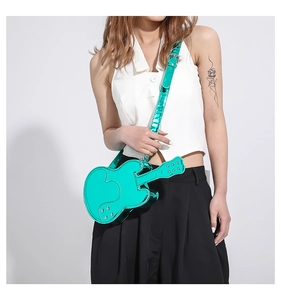 Macro view of mint green metallic violin shaped purse with glossy finish and wide strap
