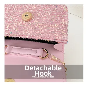 Detail of pink sequin handbag showing detachable gold chain hook and magnetic closure