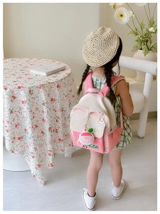 Pink and cream contrast backpack for kids with a cute strawberry bunny charm