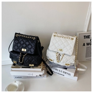 Close-up of quilted PU leather backpacks with chain straps in black and white styles