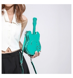 Detail of mint green violin-shaped crossbody bag with heart texture and silver rivets