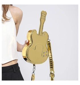Detail view of a laser gold guitar-shaped crossbody bag with heart-shaped stitching