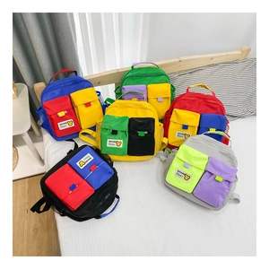 Flat lay of colorful color-blocking canvas kids backpacks with dual front pockets