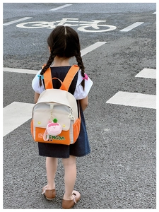 Close-up of kids canvas backpack with contrast colors and letter print in outdoor scene