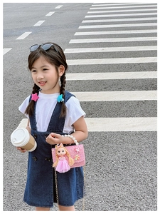Detail of pink glitter girls handbag with pearl handle and 3D princess doll charm accessory