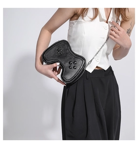 Detailansicht einer schwarzen Crossbody-Tasche in Gamecontroller-Form mit Silberkette