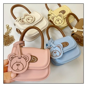Detail view of mini PU leather children's bear handbags in five pastel colors with gold chain
