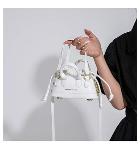 Close-up of white leather mini handbag with gold hardware and FASHION & BAGS logo