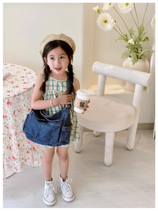 Detailed view of kids denim crossbody bag in dark wash with functional pockets