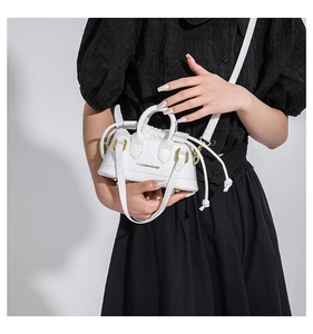 Detail shot of mini white tote bag featuring drawstring closure and fashion typography