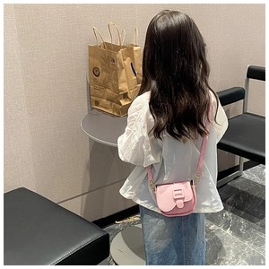 Detailed back view of a pink mini crossbody bag with litchi texture and gold hardware