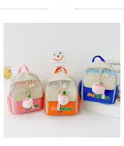 Detailed view of color-block canvas backpacks with side mesh pockets and peach pendants
