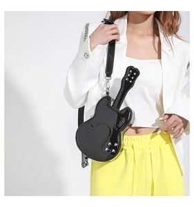 Detail showing violin shaped PU leather crossbody bag with heart patches and metal rivets