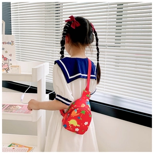 Detailed view of the red dinosaur print on the water-drop shaped polyester kids chest bag