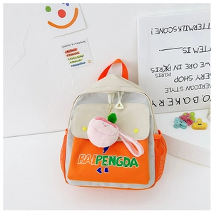 Detail of color-block canvas kids backpack with orange mesh pocket and peach charm