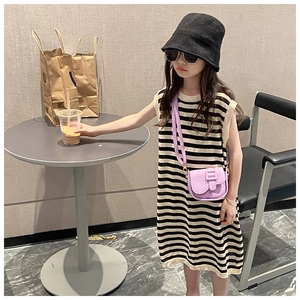 Girl's mini crossbody bag shown on a model wearing a striped sleeveless dress and hat