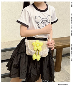 Close-up of children's woven bag with white lace trim and yellow flower decoration