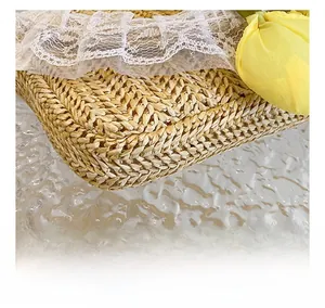 Close-up of hand-woven straw bag with delicate white lace and yellow tulip decor