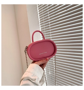 Pink mini chain bag close-up showing lychee grain leather and fashion text print