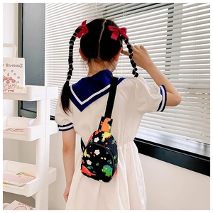 Close-up of kids dinosaur chest bag with colorful patterns and adjustable nylon strap
