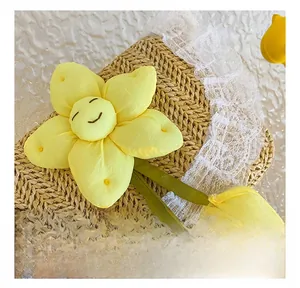 Close-up of handmade yellow fabric flower with smiley face and delicate lace trim