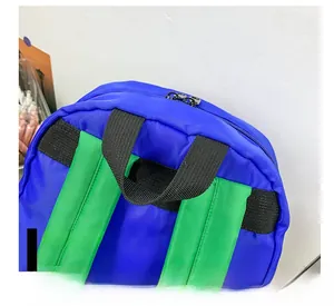 Detailed close-up of reinforced handle and contrast color nylon straps on a kids backpack