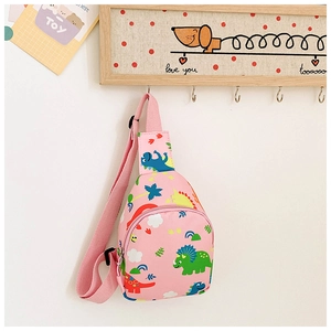 Detail of pink kids crossbody bag with colorful cartoon dinosaur prints and zippers