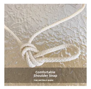 Detail of soft cream woven cotton rope shoulder strap with artisanal knot design