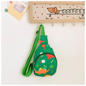 Close-up of green kids dinosaur sling bag with adjustable strap and dual zippers