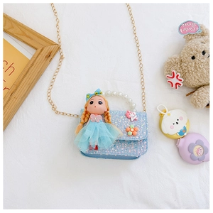 Detail of girls mini sequin bag with pearl handle, doll ornament and metal chain strap