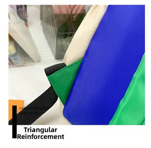 Detailed view of reinforced triangular stitching on multicolor lightweight canvas backpack