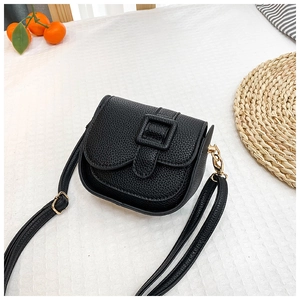 Detail of a black mini crossbody bag with litchi texture PU leather and gold hooks