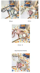 Dettaglio delle borse a tracolla peluche a forma di coniglio in blu, bianco e rosa con pompon