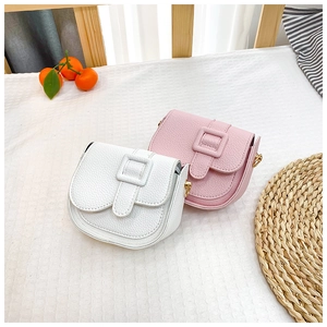 Close-up of mini PU leather shoulder bags in white and pink with golden metal hardware