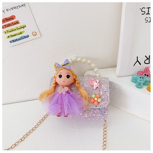 Detail of purple sequin kids bag featuring pearl handle and cute character ornaments