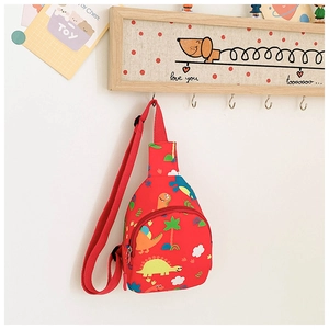 Detail of red canvas kids chest bag featuring colorful cartoon dinosaur prints