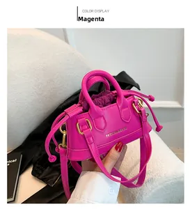Detail of rose red mini handbag with drawstring liner and fashion gold lettering